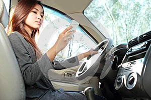 Young woman texting while driving