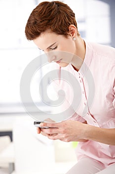 Young woman texting on phone