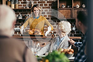 young woman with thanksgiving turkey for holiday dinner