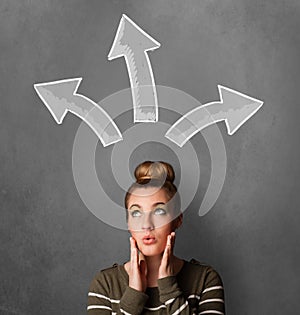 Young woman thinking with arrows above her head