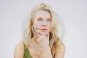 Young woman, thinking and decision in studio with ideas, memory and focus by gray background. Girl, model and think with