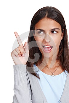 Young woman, thinking and finger with idea, solution or plan against white studio background. Isolated female pointing