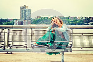 Young woman thinking outdoors by river in New York City