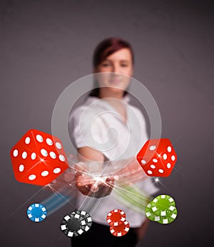 Young woman throwing dices and chips
