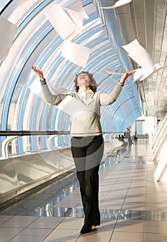 Young woman throwing documents