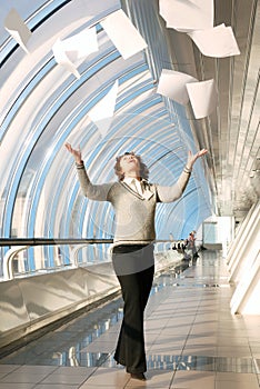 Young woman throwing documents