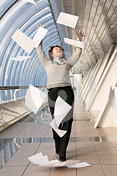 Young woman throwing documents