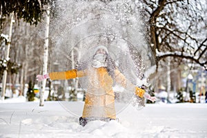 Young woman throwing snow
