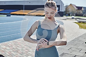 young woman in tight activewear checking