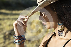 Young woman tipping a cowboy hat. photo