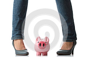 Young woman about to smash piggy bank