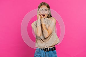 Young woman touching cheek, closing eyes with expression of terrible suffer from painful toothache