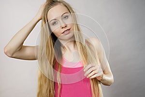 Young woman touching her long hair