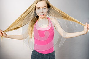 Young woman touching her long hair