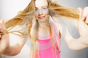 Young woman touching her long hair