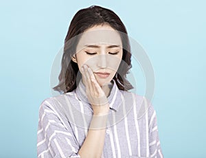 Young woman touching mouth with hand with painful expression