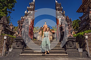 Young woman tourist in budhist temple Brahma Vihara Arama Banjar Bali, Indonesia