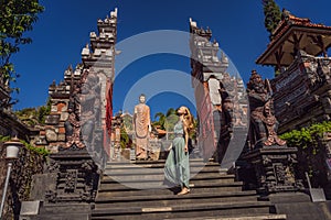 Young woman tourist in budhist temple Brahma Vihara Arama Banjar Bali, Indonesia