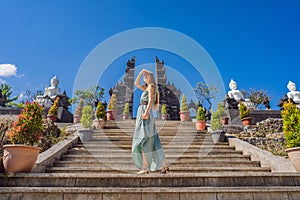 Young woman tourist in budhist temple Brahma Vihara Arama Banjar Bali, Indonesia