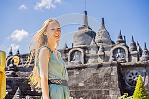 Young woman tourist in budhist temple Brahma Vihara Arama Banjar Bali, Indonesia