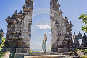 Young woman tourist in budhist temple Brahma Vihara Arama Banjar Bali, Indonesia
