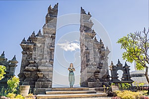 Young woman tourist in budhist temple Brahma Vihara Arama Banjar Bali, Indonesia