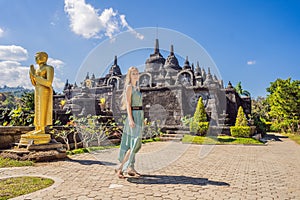 Young woman tourist in budhist temple Brahma Vihara Arama Banjar Bali, Indonesia