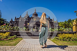 Young woman tourist in budhist temple Brahma Vihara Arama Banjar Bali, Indonesia