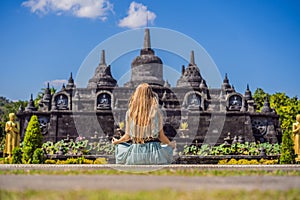 Young woman tourist in budhist temple Brahma Vihara Arama Banjar Bali, Indonesia