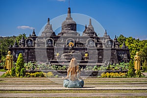 Young woman tourist in budhist temple Brahma Vihara Arama Banjar Bali, Indonesia