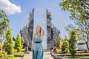 Young woman tourist in budhist temple Brahma Vihara Arama Banjar Bali, Indonesia