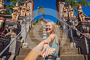 Young woman tourist in budhist temple Brahma Vihara Arama Banjar Bali, Indonesia Follow me concept