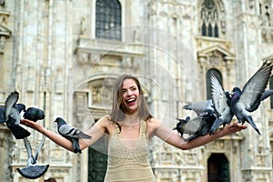 Young woman tourist on Duomo Cathedral, Milan.