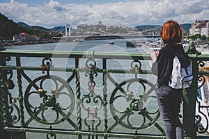 Young woman tourist enjoying panoramic view Danube river and Liberty Bridge. Budapest. Hungary.
