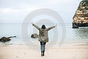 A young woman tourist enjoys beautiful views of the Atlantic Ocean and the landscape.