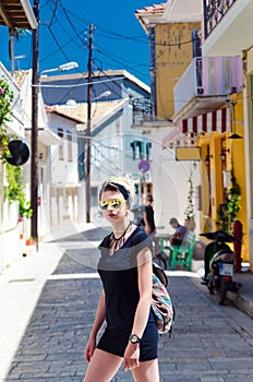 Young woman tourist exploring streets in Levkas