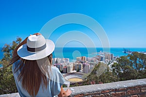 Young woman tourist looking at Malaga city. Summer holiday vacation in Spain