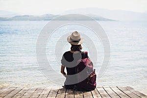 Young woman tourist looking at the sea, relaxation, vacations, travel lifestyle, summer fun, enjoying life concept