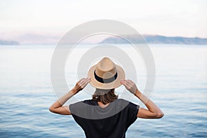 Young woman tourist looking at the sea, travel concept.