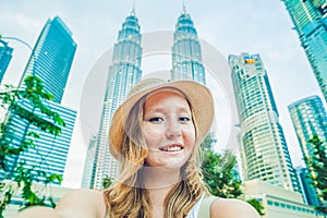 Young woman tourist making selfie on the background of skyscrapers. tourism, travel, people, leisure and technology concept