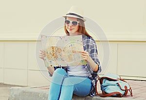 Young woman tourist sightseeing city with paper map
