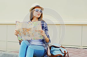 Young woman tourist sightseeing city with paper map