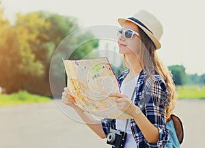 Young woman tourist sightseeing city with paper map