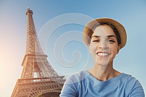 A young woman tourist is taking a selfie picture in front of the Eiffel Tower in Paris, France, Europe.