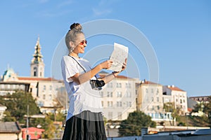 young woman tourist visiting Belgrade, Serbia looking at the map