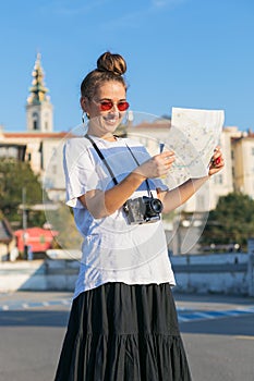 Young woman tourist visiting Belgrade, Serbia looking at the map