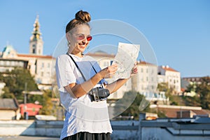 Young woman tourist visiting Belgrade, Serbia looking at the map