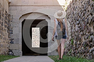 Young woman tourist walking on ancient sites. Excursions to ancient cities