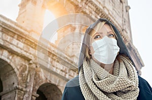 Young Woman Tourist Wearing Face Mask Walks Near the The Roman Coliseum In Rome, Italy