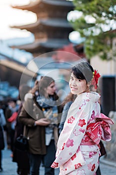 Young woman tourist wearing kimono enjoy in Yasaka pagoda area near Kiyomizu dera temple, Kyoto, Japan. Asian girl with hair style